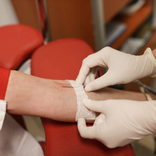 Nurse in gloves performing a home blood test for STD screening in Dubai